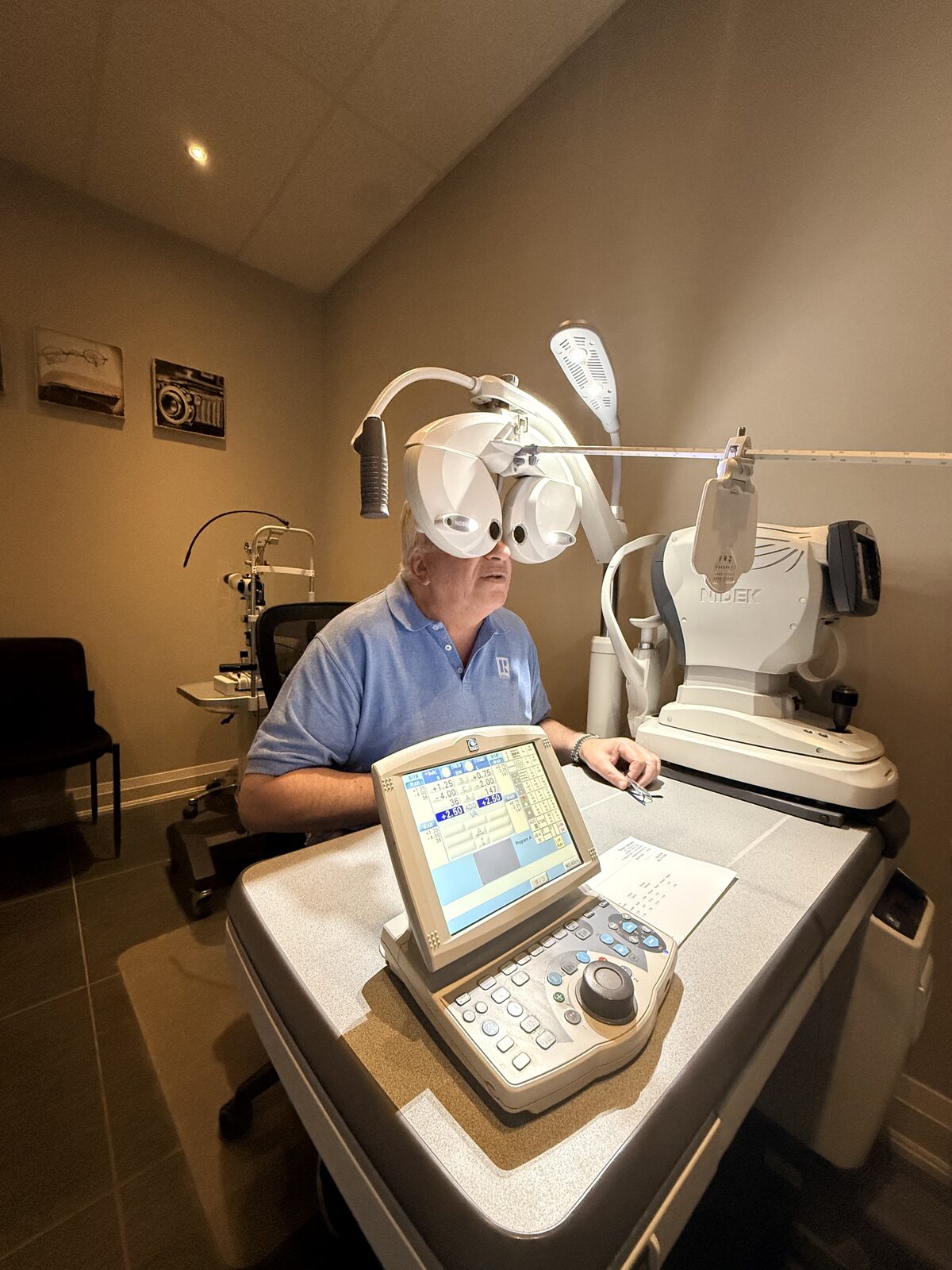 Patient looking through a phoropter during a comprehensive eye exam to evaluate presbyopia and near vision changes after 40